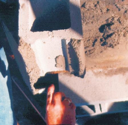 TM: A3 6D LAYING THE FIRST COURSE Plumb with level Stretch line to corner to lay blocks between Marker board Foundation Mortar full width of block when laying first course Details of how to construct