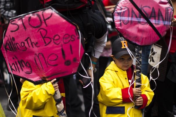 Children hold banners during a protest against Monsanto and