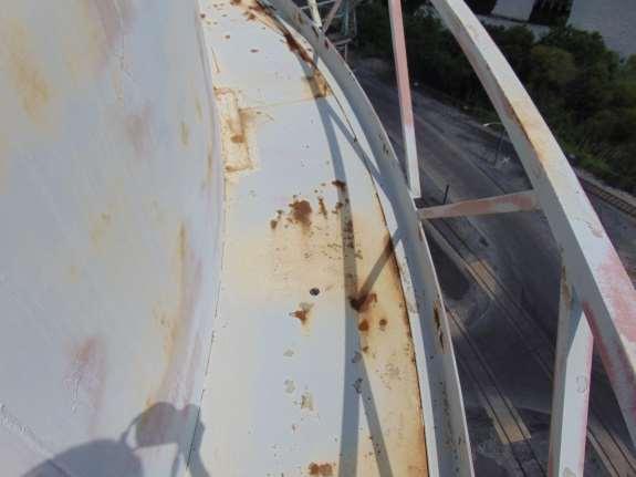 Photo shows where water is ponding on the balcony floor, causing deterioration of the paint and