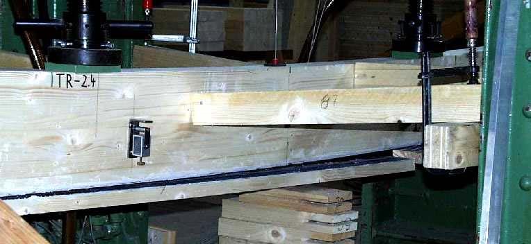 Figure 4 shows a CFRP reinforced glulam beam with a typically delamination of the timber facing shortly before the global failure occurred.