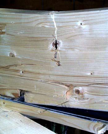 Failure of the timber facing at a knot (bottom right) Failure of a finger joint above the reinforcement (bottom left) Compression wrinkle (top middle) Failure of a finger joint CFRP fibres on the