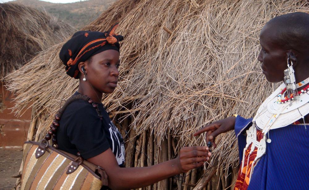 Dorice Kaunda,Tanzanian Broadcast Corporation, captures an interview with a Maasai woman in Mairowa village near Arusha, using her Sansa MP3 recorder.