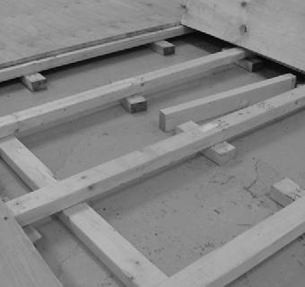 As shown, the wood floor joists do not