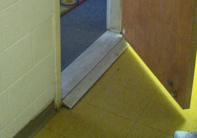 One half of the space is capable of exiting directly to the exterior. The Floor consists of a sheet sport floor product with game lines. The walls are painted CMU. Wall pads protect the masonry walls.