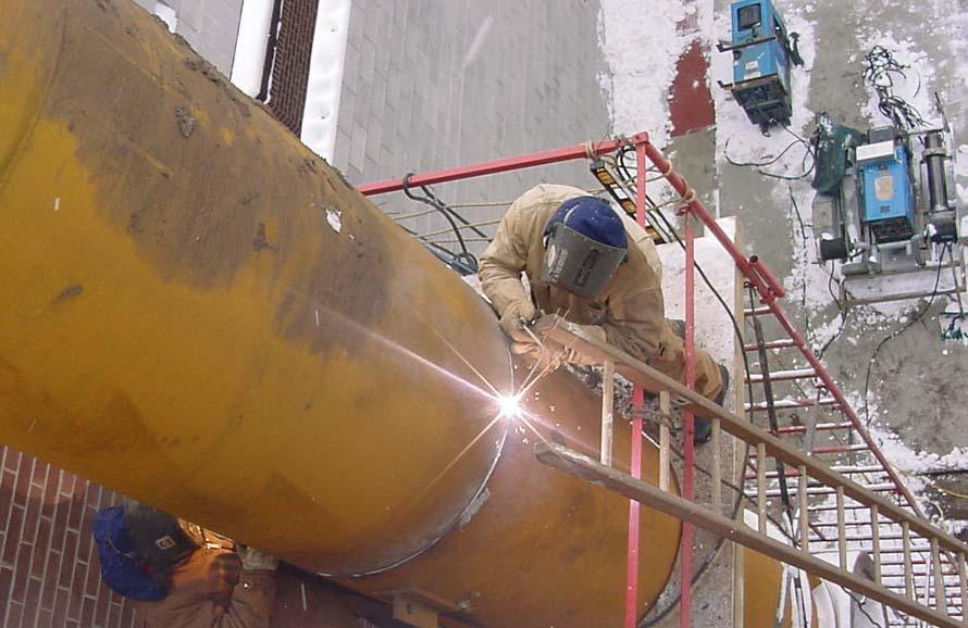 Welder on scaffolding while Crane