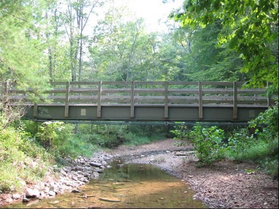 The following are examples of two pedestrian bridges constructed using FRP structural sections. 3.1 Clear Creek Bridge A pultruded FRP composite I-girder pedestrian bridge (Fig.