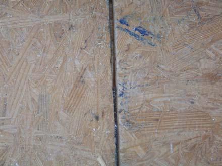 Floor decking in the upstairs left side hallway has large un-supported gaps that should be