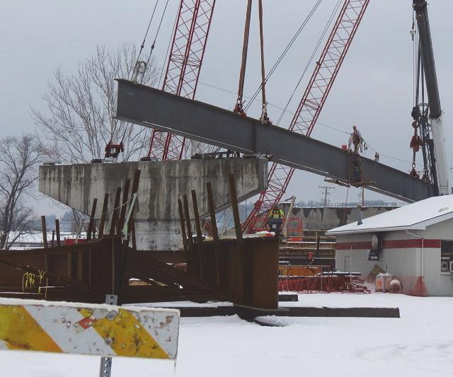 The first girder was set in February for the span from the Ohio abutment crossing over Pier 8 (left).