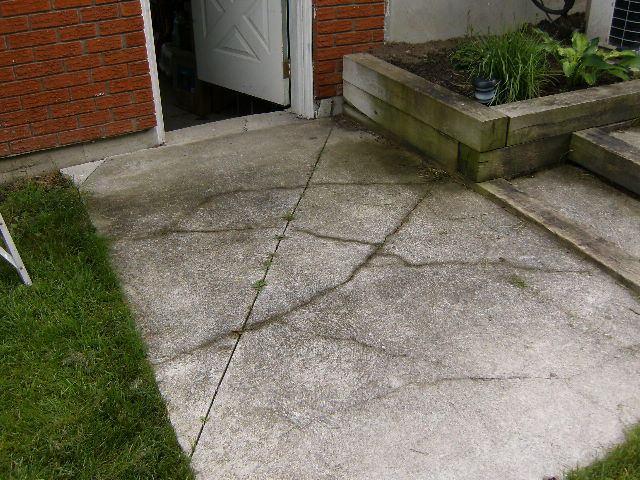 It is difficult to improve this situation without re-grading the walkway adjacent to the foundation. The damage created under the Garage door has been caused by this slope.