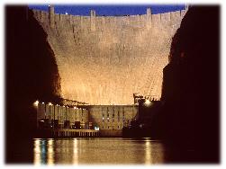 Water is allowed to flow through tunnels in the dam, to turn turbines and thus drive generators.