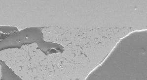 Figure 3. SEM micrograph of a foam strut sintered to a solid tube.