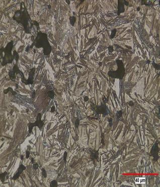 The microstructure is predominantly upper bainite with plates of ferrite about 10 µm long and less than 1 µm thick.
