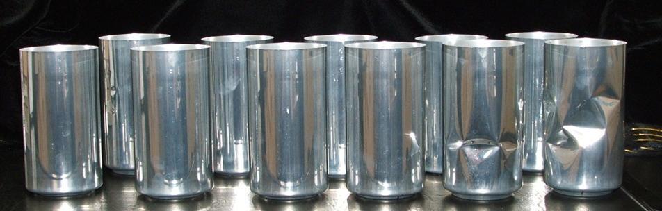 The Figure 3: Deformed cans after the axial load test. 2 out of 11 failed due to side wall buckling while the rest failed due to base squat.