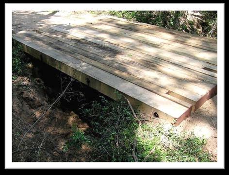 Portable bridgemats (also referred to as dragline mats, skidder mats, bridge mats, skidder bridges, timber bridges, and portable glulam panel bridges) are a readily-available and proven method of