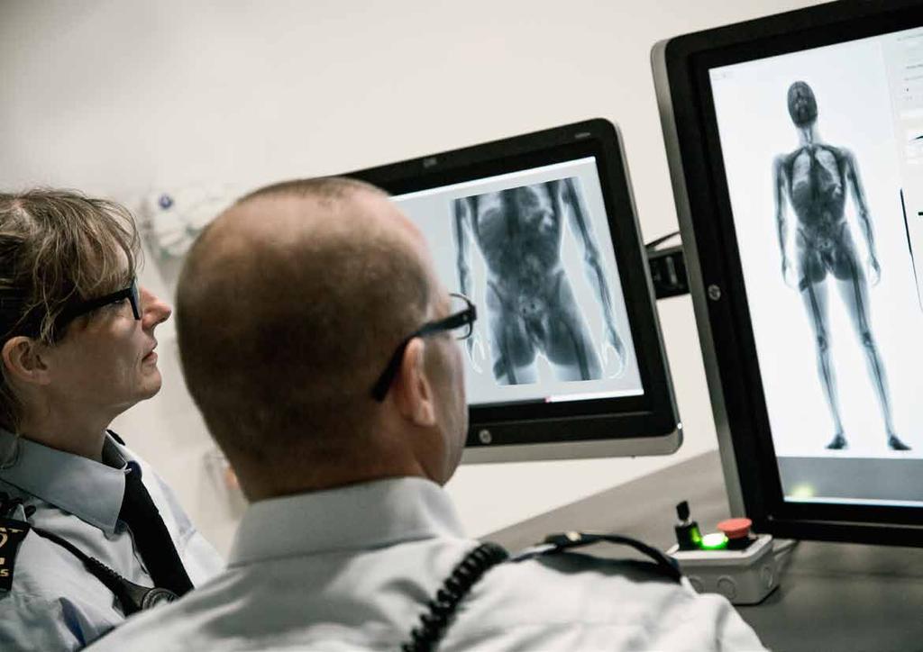 Denmark Customs using body scanner At Copenhagen airport, Customs officers Peter Brandt Jensen and Suzanne J. Kristiansen analyse a picture taken by a body scanner of a man having ingested narcotics.