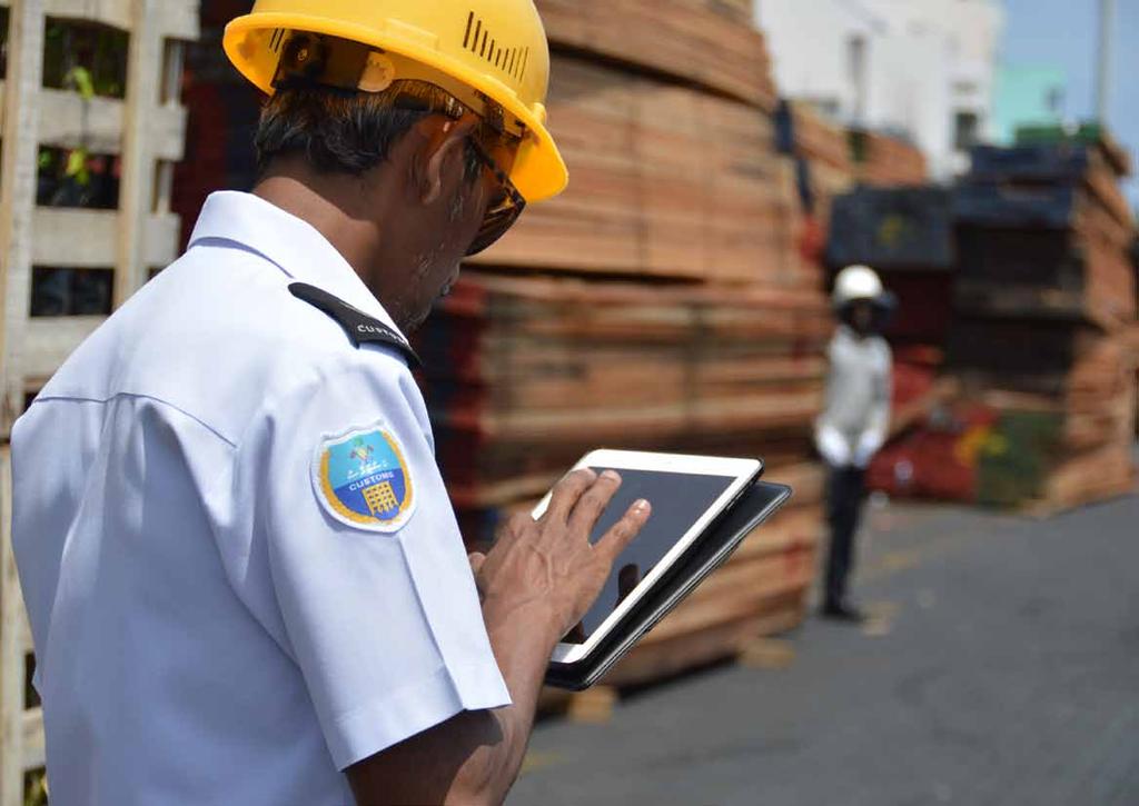 Maldives Paperless declaration processing and cargo examination Bundles of timber are being examined by an officer using
