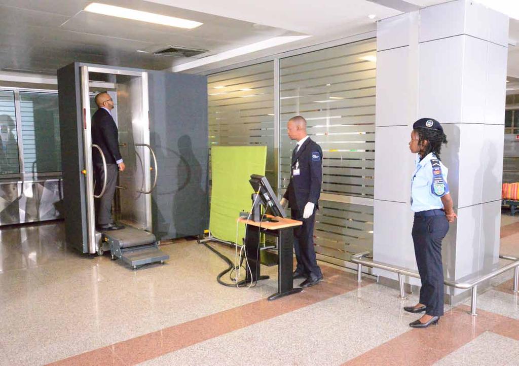 Angola Passenger control A passenger is checked using a body scanner, instead of being