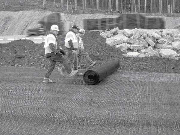 IMAGE 3: Rolling out Tensar Geogrid. 2.