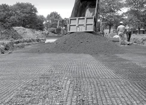 IMAGE 8: Dumping aggregate fill on top of Tensar Geogrid over competent subgrade. 5. Dumping and Spreading Aggregate Fill Generally, at least 6 in.