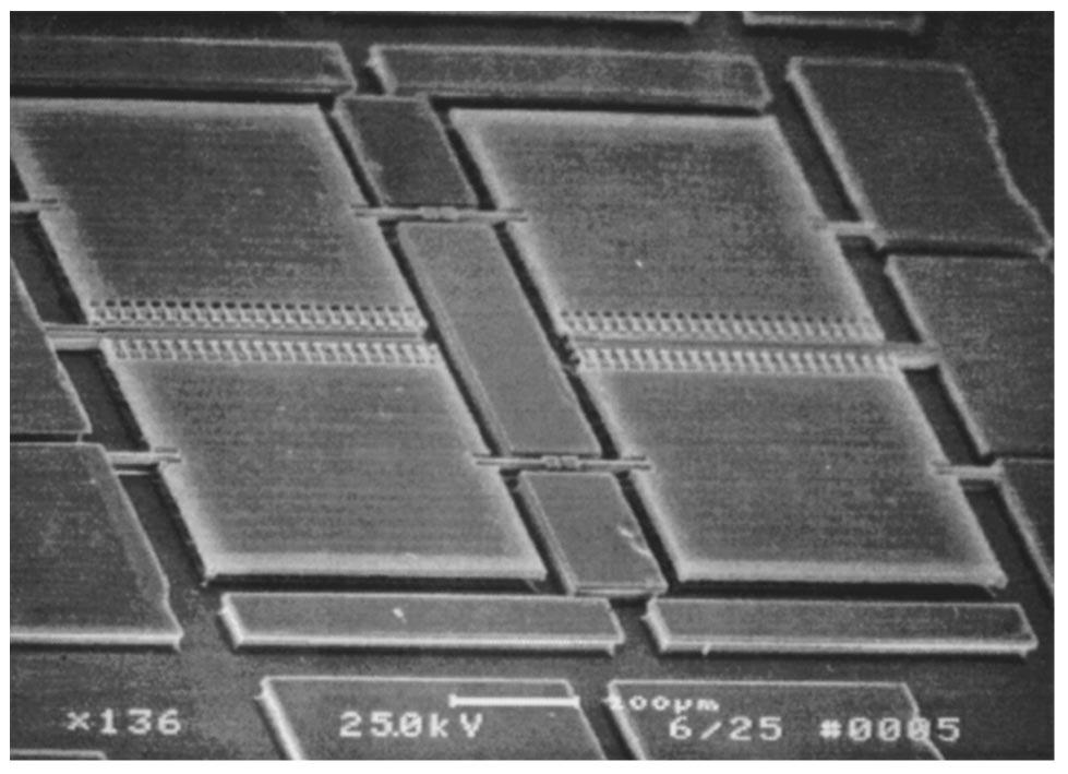 Fig. 5 Schematic representation of the vertical near-comb actuator. Fig. 3 SEM photograph of four suspended 300 240 m mirrors. Deposition of PECVD silicon dioxide.