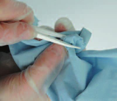 6 When test is complete, remove debris from tweezers with tissue paper or similar
