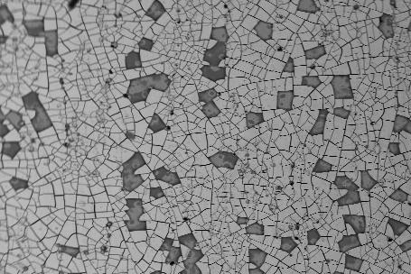 Surface SEM observation of a black anodic film after a failed peel-test These observations are compatible with scratch-tests results.