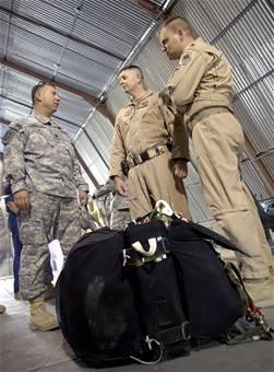 (From left) Army Lt. Col. Robert Gagnon, Maj. Neil Richardson and Maj. Daniel DeVoe review procedures for testing the new Joint Precision Air Drop System in Afghanistan.