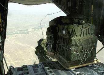 Joint Precision Air Drop System bundles fall out of the back of a C-130 Hercules Aug. 25.