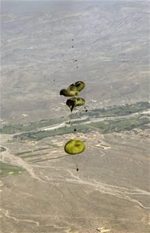 Joint Precision Air Drop System bundles float to the ground after being dropped from a C-130 Hercules Aug. 26.