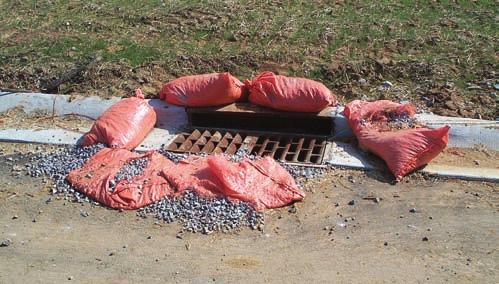Protecting Culvert and Channel Inlets and Outlets 47 Poor placement of stone bag inlet dam;