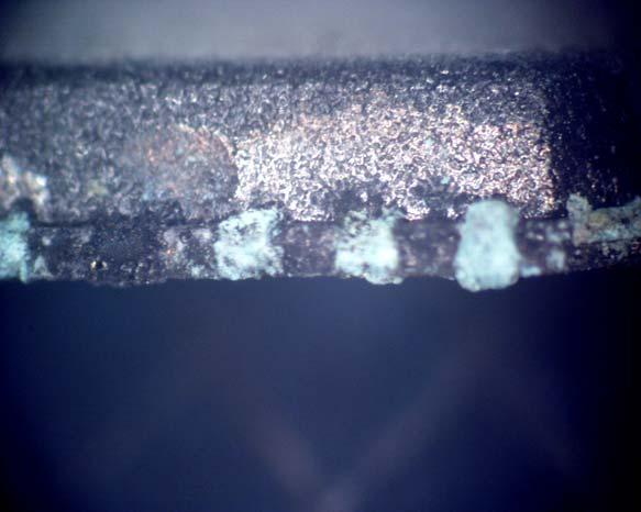 exposure, noticeable creep corrosion products were identified as bridging leads (see Figure 13 and Figure 14).