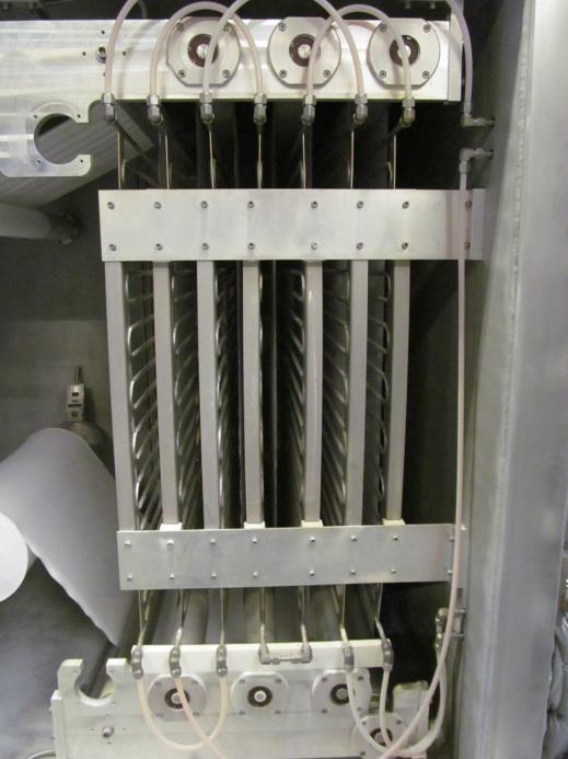 A typical processing system for web based materials (Figure 1), consists of a processing chamber connected to a vacuum pump, a set of wind/rewind spindles, and a