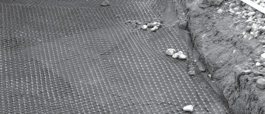 Anchor the geogrid with small piles of aggregate fill (Image 6), if necessary.