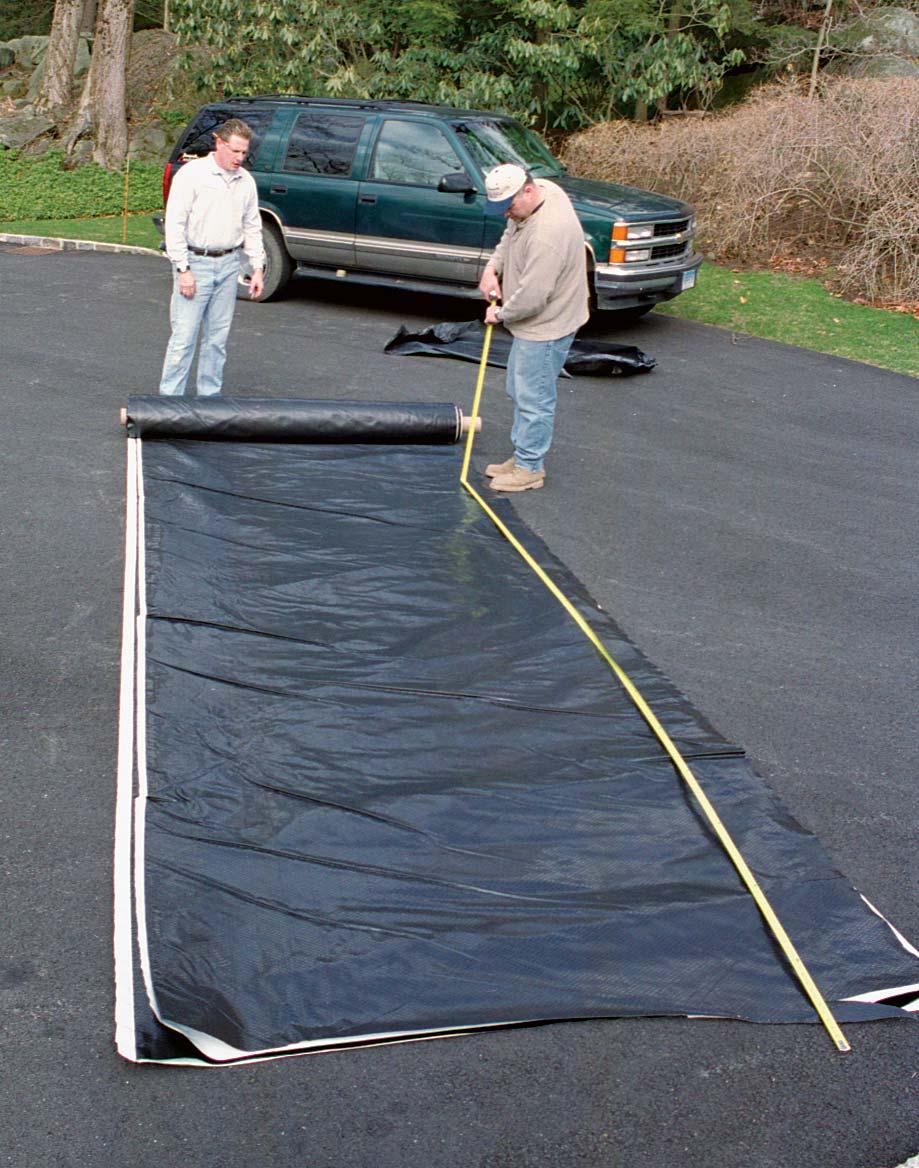 HEAVY-DUTY LINER IS CUT TO SIZE IN THE DAYLIGHT Plastic liner is more easily handled in the driveway.