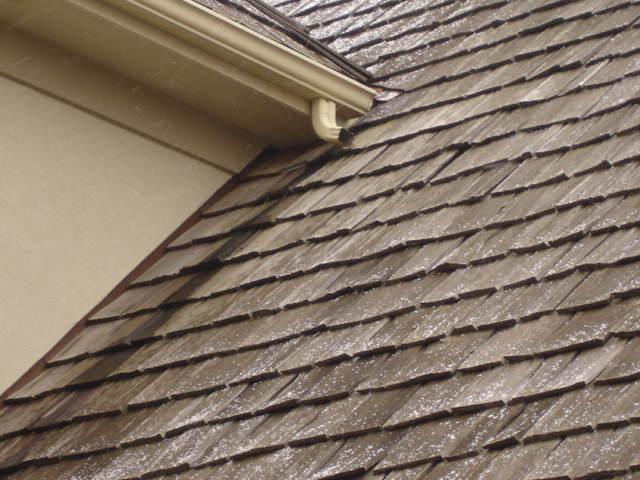 3. Gutter and Downspout Placement Gutter end downspout draining directly onto a cedar shake roof in a 12,000