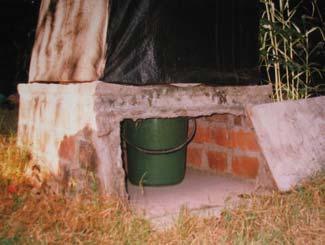 The vent pipe will function better if the vault is well sealed. Two bricks can be mortared on the base slab to locate the best position for the bucket which is directly under the pedestal.