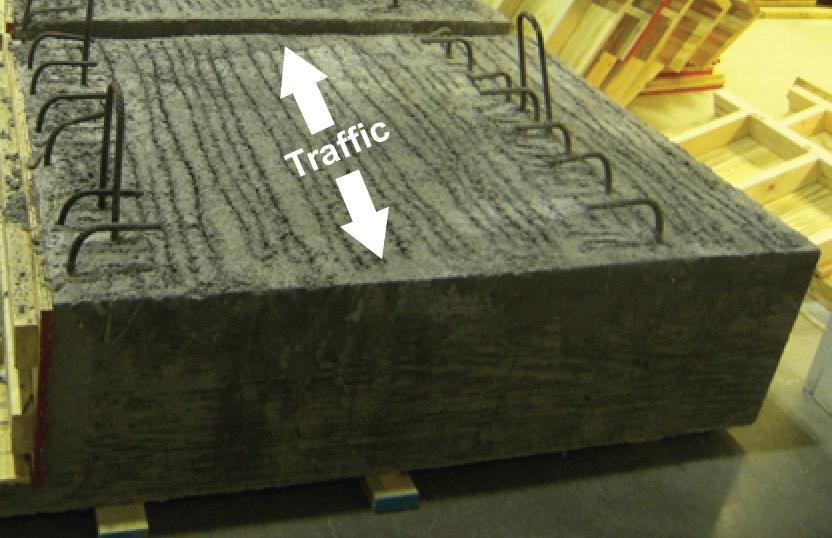 The top surface of the girders was given a raked finish shortly after the concrete was placed. Figure 48 shows the resultant roughened surface.