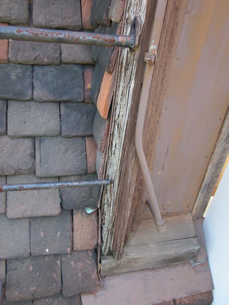 Photo 6 Deteriorated wood trim at south fire escape exit doors.