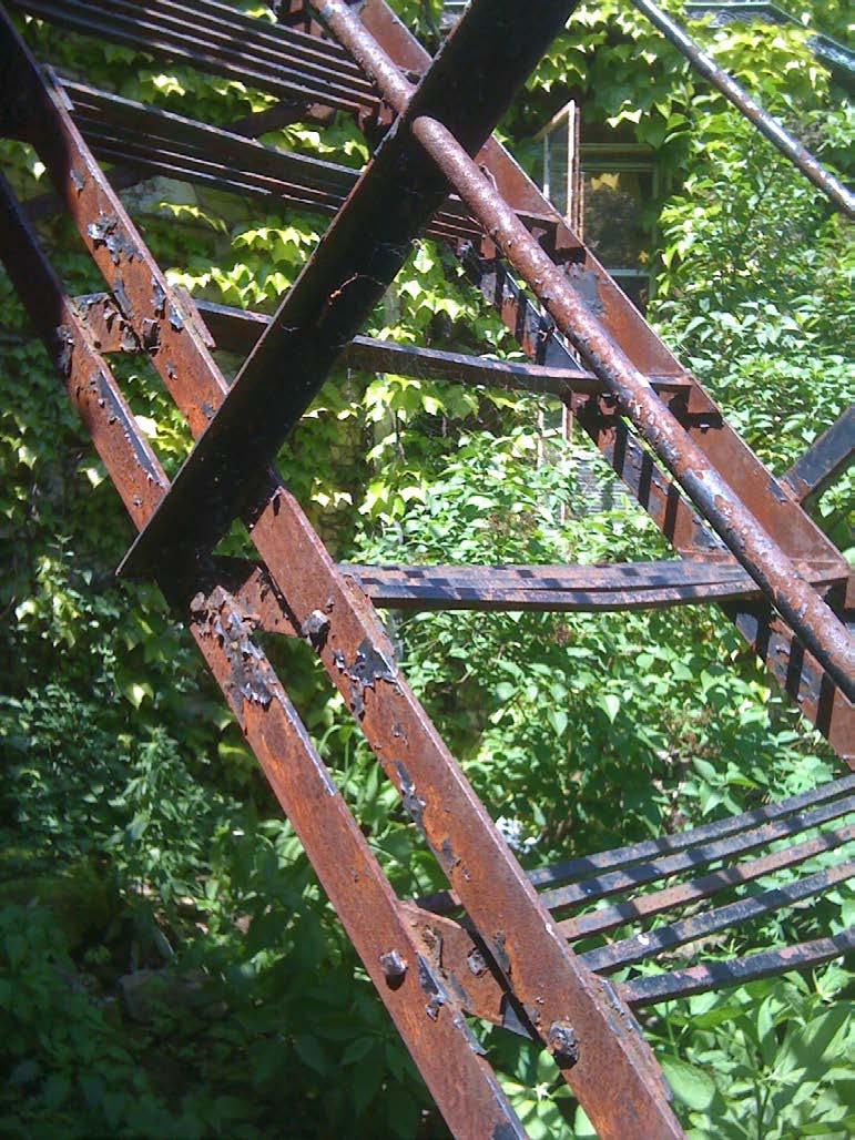 Photo 8 Surface corrosion and tread deterioration on fire escape.