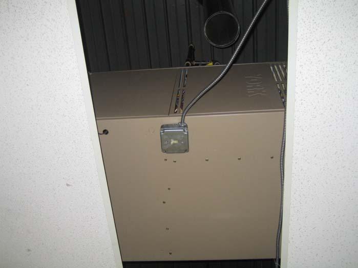 PHOTOGRAPH 16 Unit heater present above suspended ceiling tile.