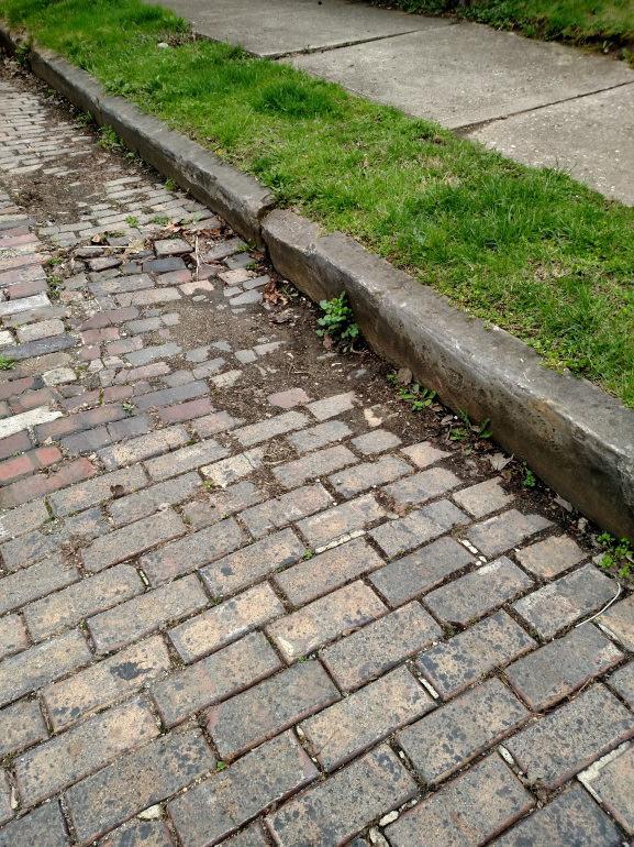 Section V - Prioritization Process: 1. Street structural damage noted due to curb an