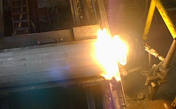 Figure 4. Coating with grease. Acetylene. With this method, acetylene is ignited in front of the billet, generating carbon black.