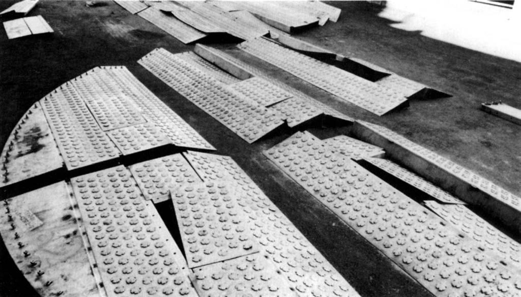 Valve cap trays fabricated of Type 410 stainless steel are being assembled for installation in a crude distillation tower. Photograph: Glitsch, Inc.