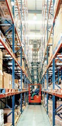 They are often supported by more conventional handling devices which help by depositing and picking up pallets at the end of the racking aisles.