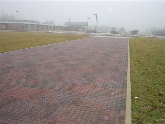 During a rain event, stormwater flows through the porous surface, drains into the crushed stone sub-base beneath the pavement, and remains stored until stormwater can infiltrate into the soil or, in