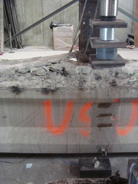 31 Fig. 4.7 Cracking prior to failure of mid-span test maintained until the girder had an ultimate failure of concrete crushing.