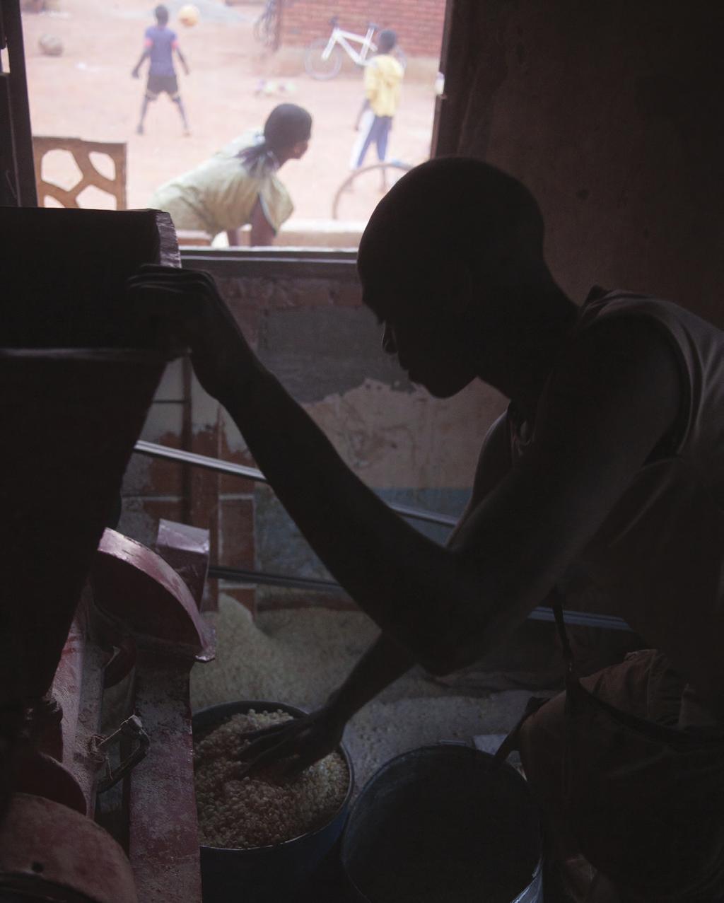 MALAWI A farmer is grinding corn.