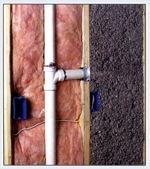Air gaps and voids caused by pipes compressing insulation in fiberglass insulated wall cavities are eliminated.