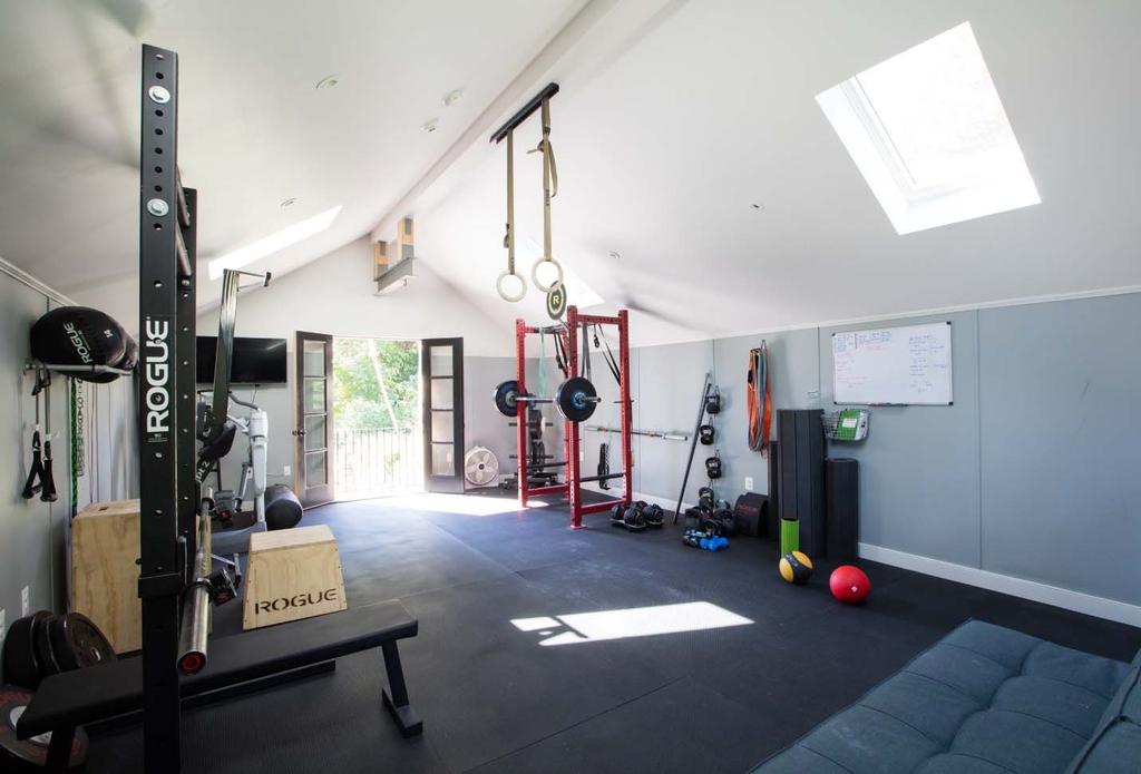 The interior of the garage is open with the exception of a set of stairs at the rear to enter the second floor. The second floor is the owner s personal CrossFit gym.