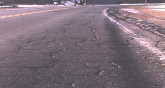 Fig 3. High severity alligator cracking 2. Longitudinal cracking: Longitudinal cracks are long cracks that run parallel to the center line of the roadway.
